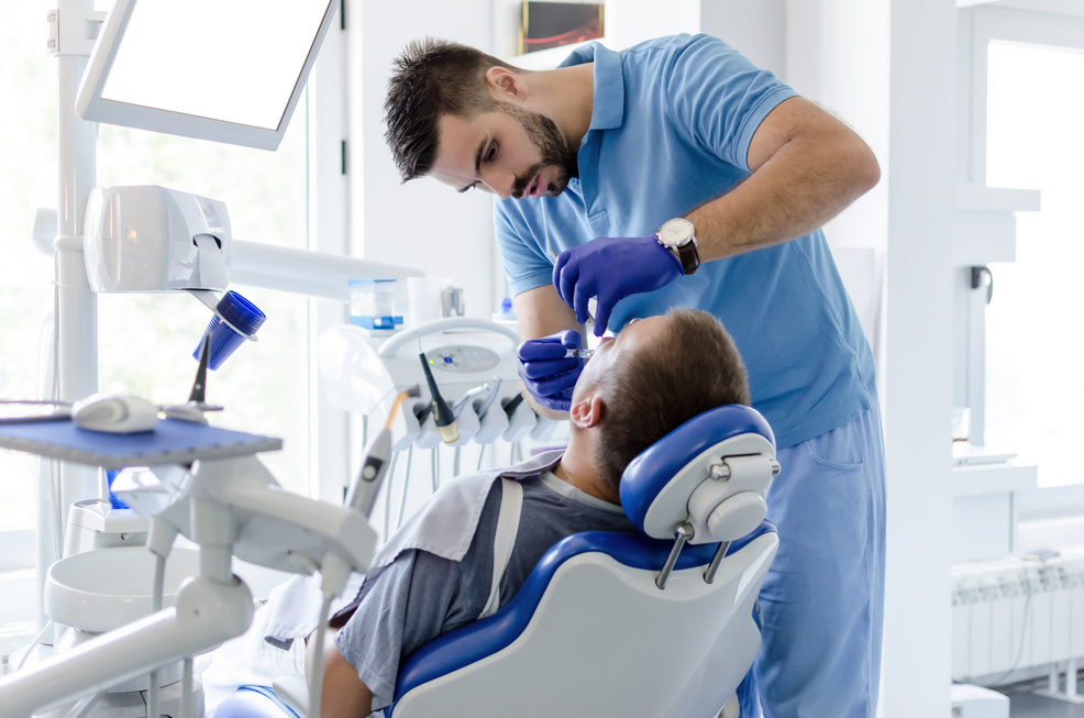 Dentis giving anesthesia to patient